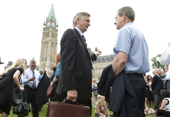 Senators, parliamentarians and their staff are shown after being evacuated from Parliament Buildings following an earthquake in Ottawa, Canada, on Wednesday.